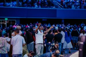 People Praying in a Stadium 